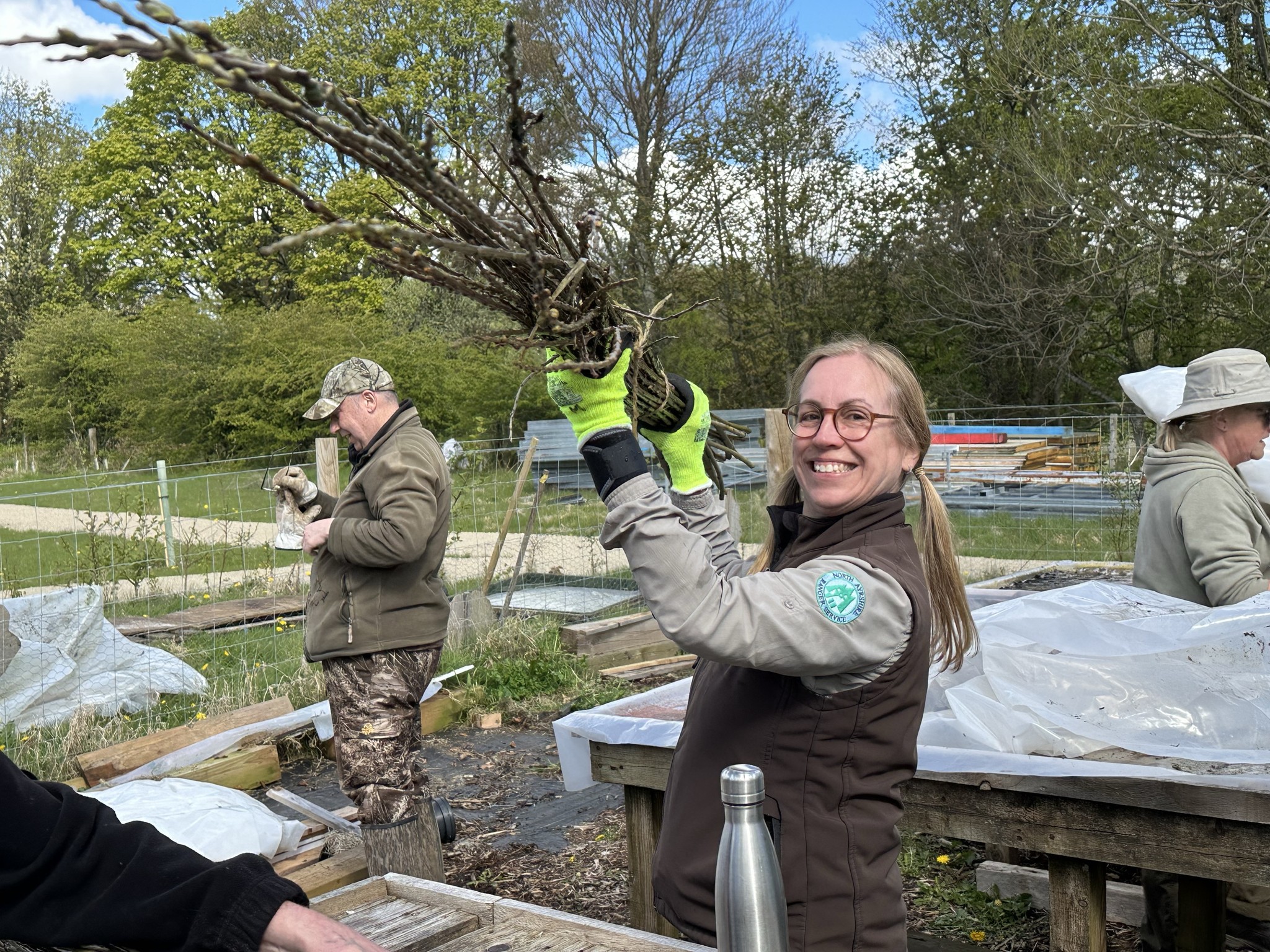Countryside Ranger Sallie smiling as clearing branches at Eglinton Community Garden