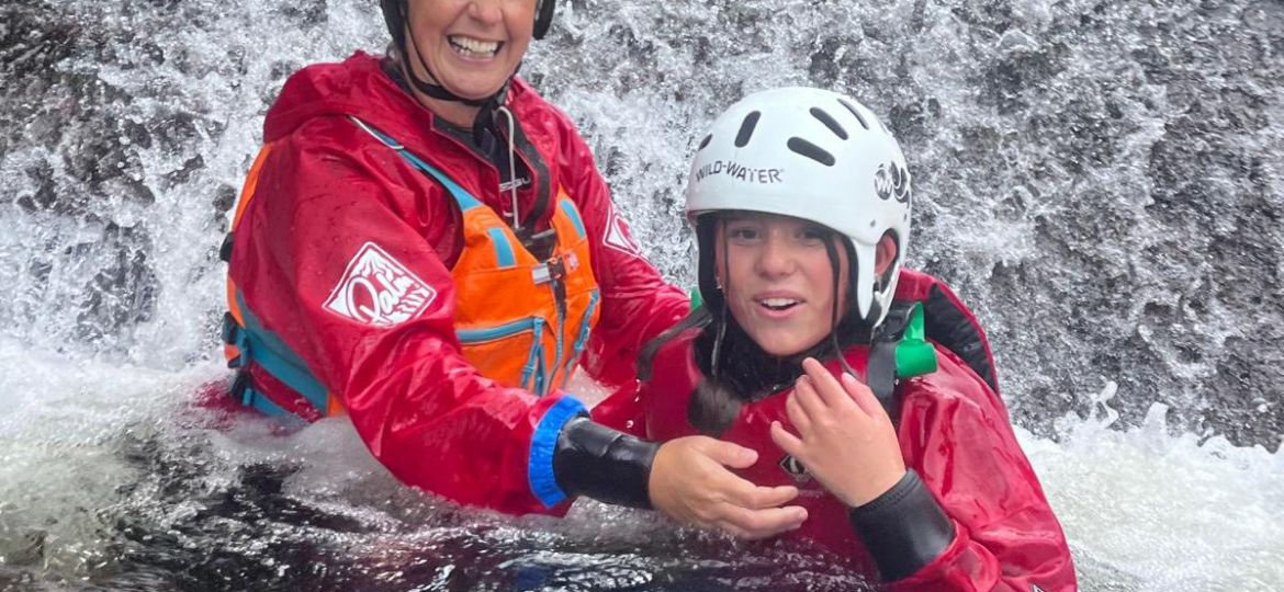 Instructor and pupil in water on outdoor gorge walking expedition