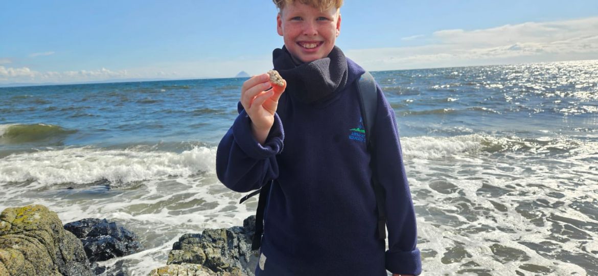 St Peters pupil holds shell on Arran coastline
