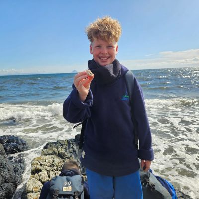 St Peters pupil holds shell on Arran coastline
