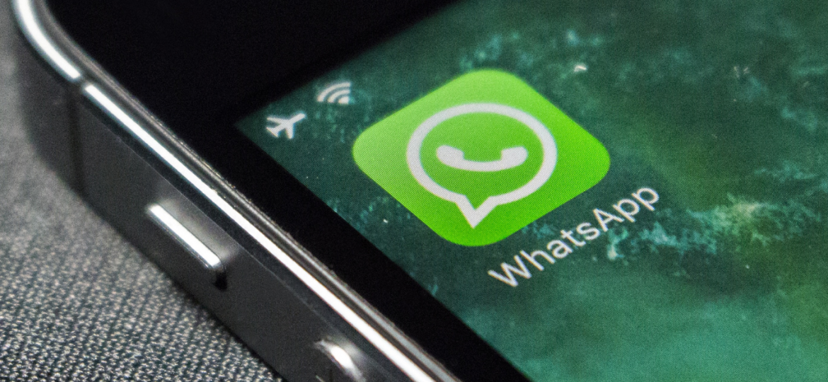 Phone with WhatsApp icon on screen