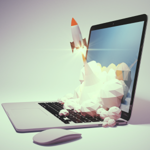 Laptop with rocket taking off from keyboard