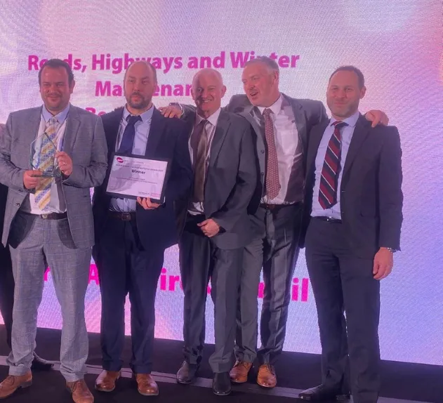 Winners on stage collecting their APSE award