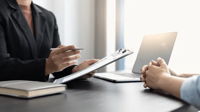 two people in a workplace environment

