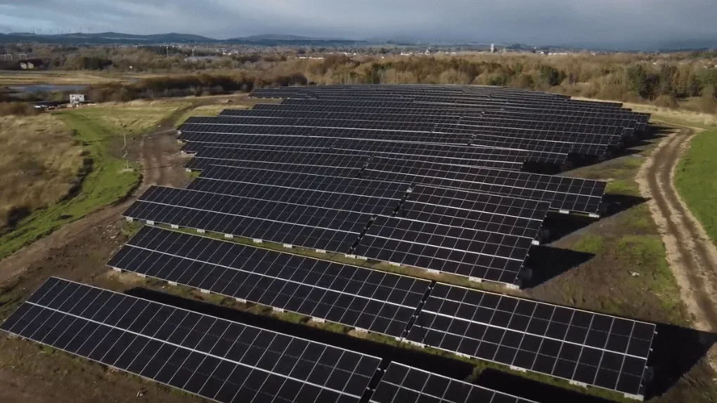 an aerial view of a solar farm in the countryside